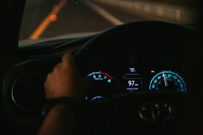a person driving a car on a highway at night