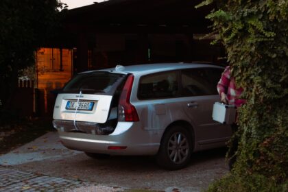 a man standing next to a parked car